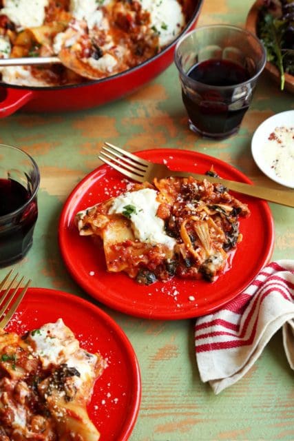 The best weeknight lasagna dinner served on a small red plate.